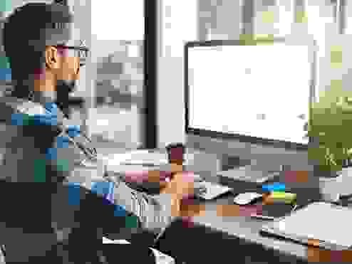 Cropped shot of a businessman working on his computer in the office